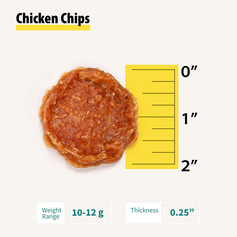 Close-up of a single round chicken dog treat chip next to a yellow ruler showing size and thickness details