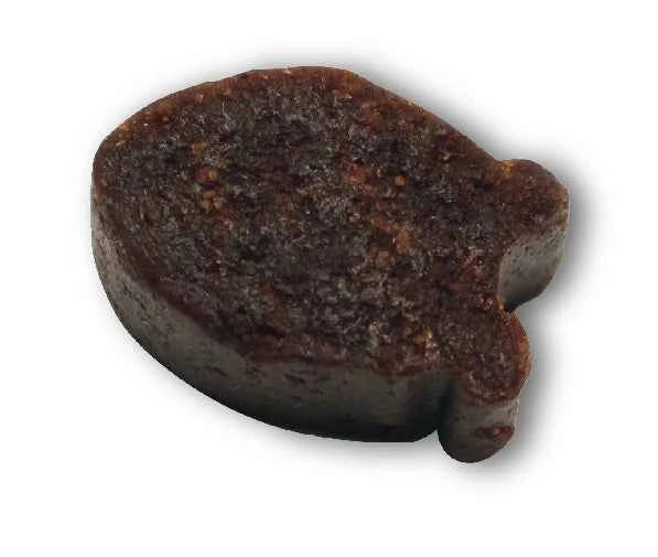 A single, dark brown, fish-shaped soft chew cat treat on a white background.