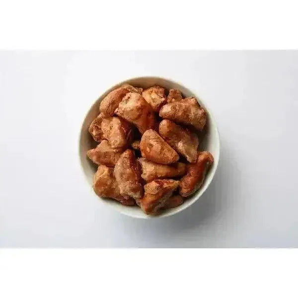 Momentum freeze dried chicken heart cat treats in a small white ceramic bowl on a plain white background.
