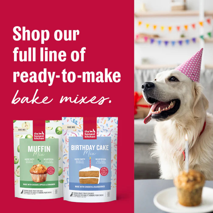 The Honest Kitchen Muffin Mix and Birthday Cake Mix bags next to a dog in a party hat.