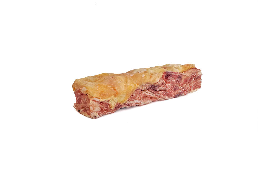 A six-inch beef skirt steak bar topped with chicken skin for dogs, shown on a white background.