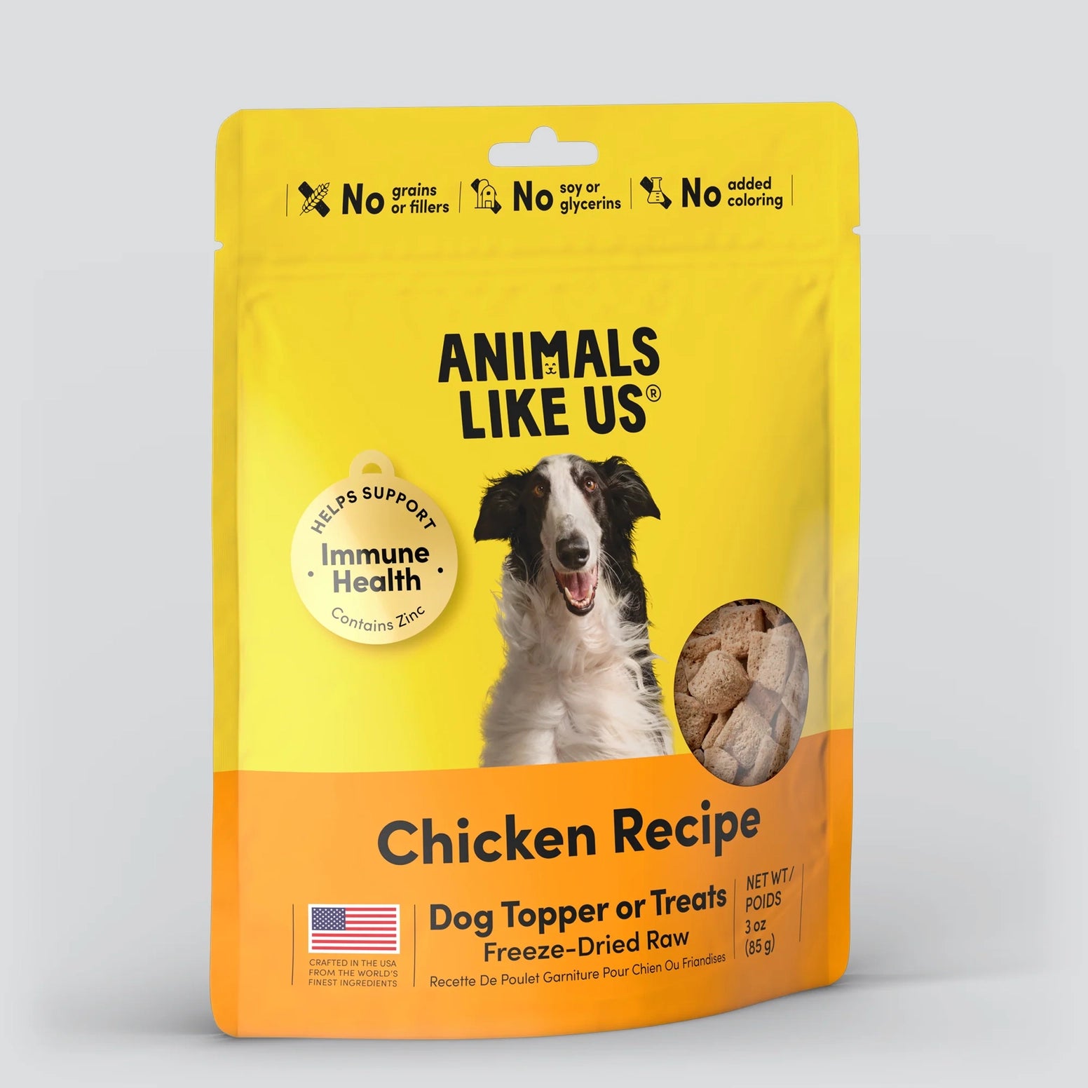 Yellow and orange pouch of freeze-dried chicken dog food topper with immune health benefits and dog image on front