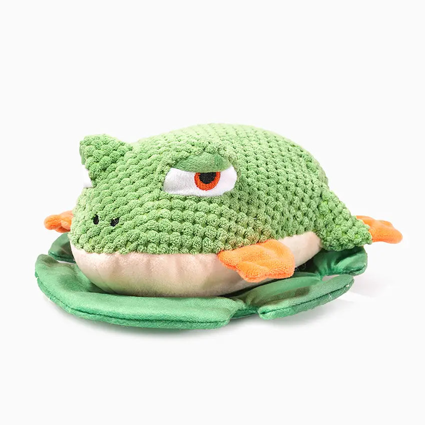 Hugsmart Pet Jungle Tails green frog plush dog toy with orange feet sitting on a lily pad.