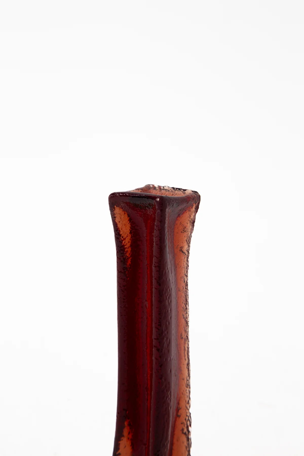 Close-up of a long-lasting red collagen dental chew for dogs with a textured surface.