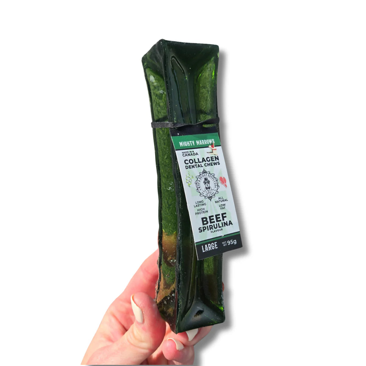 A hand holding a large green Wag & Bright Mighty Marrows Beef Spirulina Collagen Dental Chew.