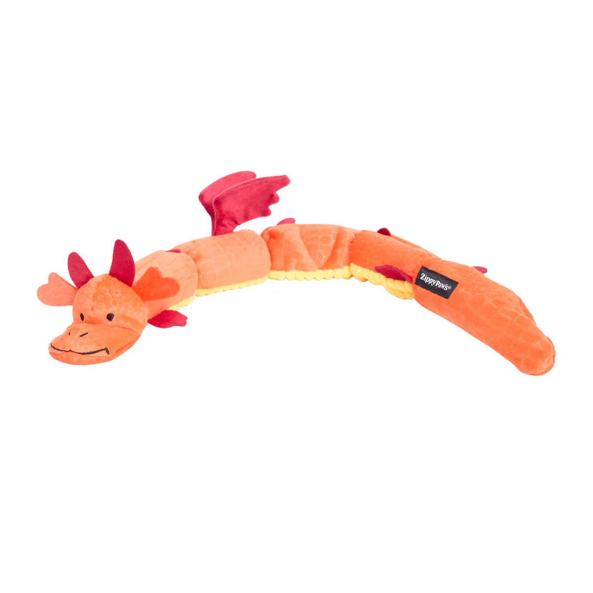 Orange plush dragon dog toy with segmented body, red wings, multiple soft fabric textures, and stitched smile