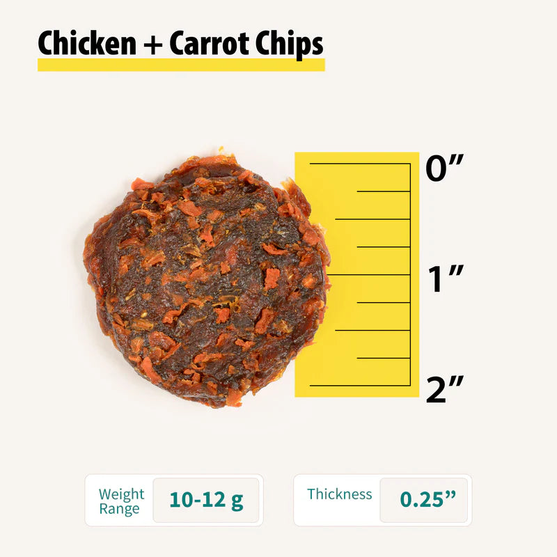 Close-up of a round chicken and carrot dog treat chip next to a yellow ruler showing size and thickness details