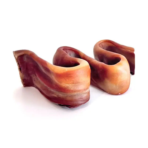 Two wavy, brown and tan Home Range Collagen Dog Chew Puzzlers on a white background.