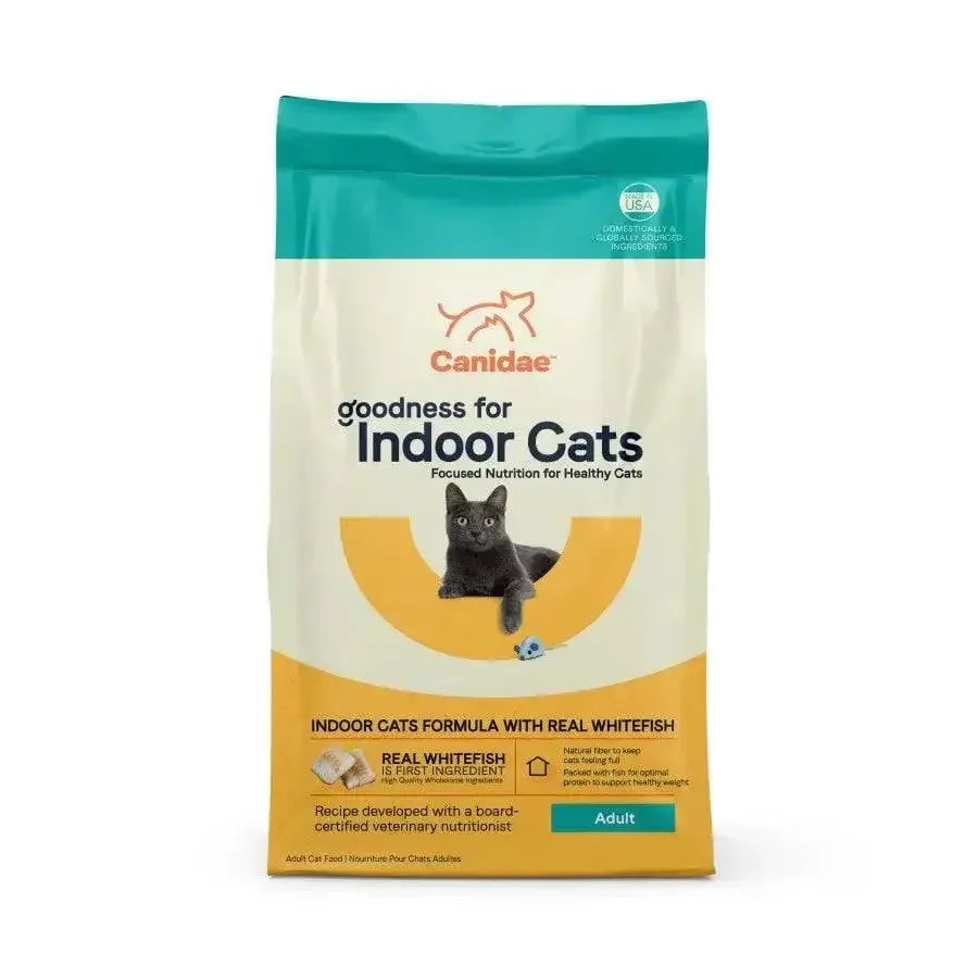 A bag of CANIDAE Goodness for Indoor Cats Formula with Real Whitefish Dry Cat Food, featuring a gray cat and blue toy mouse, made with high-quality ingredients for healthy adult indoor cats.