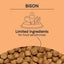 The illustration shows a bowl with a heart, leaf, and drumstick above CANIDAE. CANIDAE PURE Grain-Free Real Bison, Lentil & Carrot Recipe Dry Dog Food is ideal for sensitivities. Below is a close-up of its grain-free bison kibble.