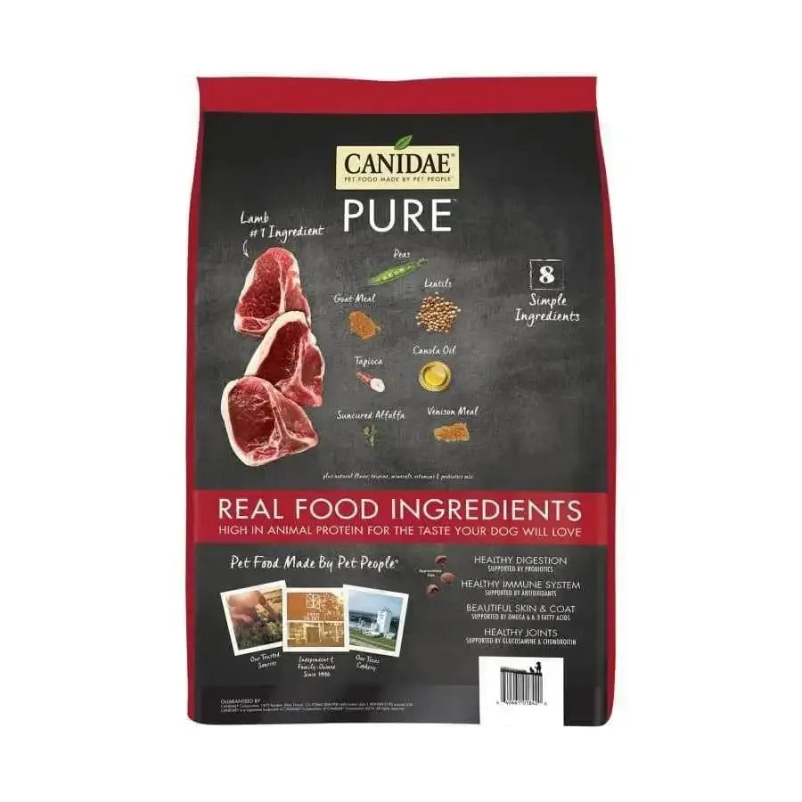 A bag of CANIDAE PURE Grain-Free Real Lamb, Goat & Venison Meals Recipe Dry Dog Food shows raw meats and simple ingredients, with text highlighting real food ingredients, high animal protein, digestive and immune support benefits.