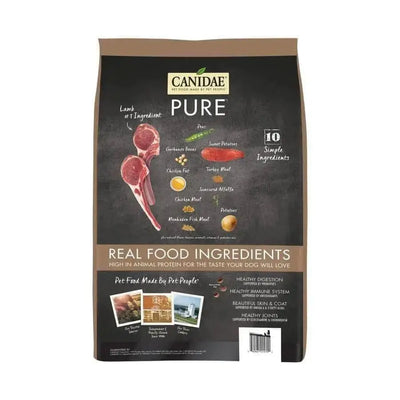 A bag of CANIDAE PURE Grain-Free Real Lamb & Pea Recipe Dry Dog Food features real lamb, peas, and sweet potatoes on the packaging, which highlights 10 simple ingredients for healthy digestion and immune support.