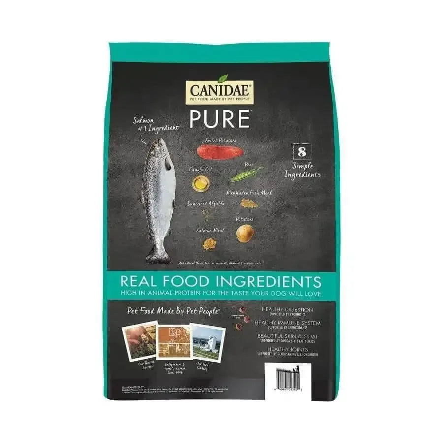 Front of a CANIDAE PURE Grain-Free Real Salmon & Sweet Potato Recipe bag shows a salmon image, ingredient list, and key benefits. The label highlights 8 simple ingredients for healthy digestion and coat in this limited ingredient dog food.