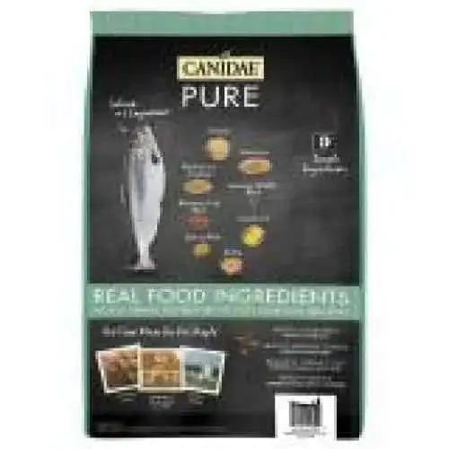 A teal and black bag of CANIDAE PURE with Wholesome Grains Puppy Real Salmon & Oatmeal Recipe Dry Dog Food features fish imagery and highlights real food ingredients in a limited ingredient formula for your pet.