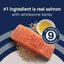A piece of raw salmon, barley, and a bowl of oil sit on a blue and beige background. Text: CANIDAE PURE with Wholesome Grains Real Salmon & Barley Recipe Dry Dog Food—real salmon #1 ingredient, 9 key clean & premium ingredients.