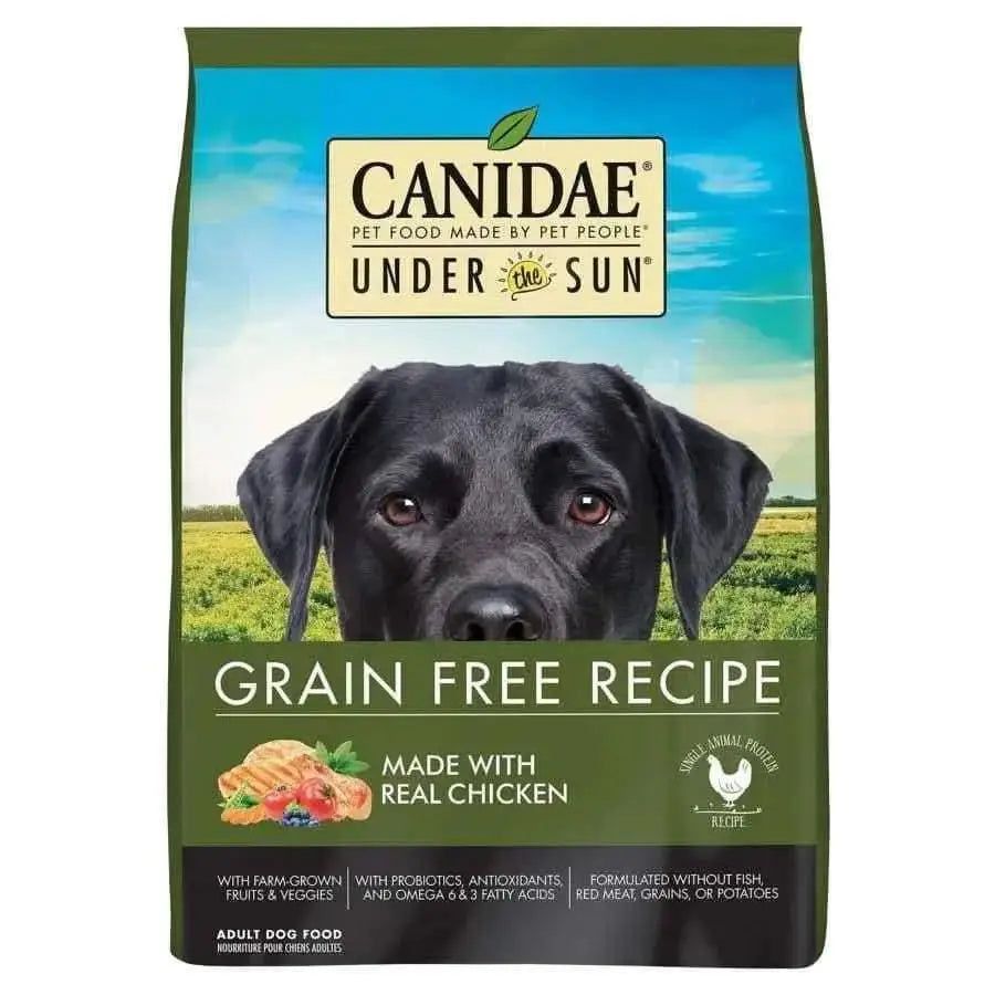 A bag of CANIDAE Under The Sun Grain-Free Chicken Recipe Dry Dog Food with a black dog’s face, green background, and text showcasing real chicken, farm-grown ingredients, fruits, and vegetables.