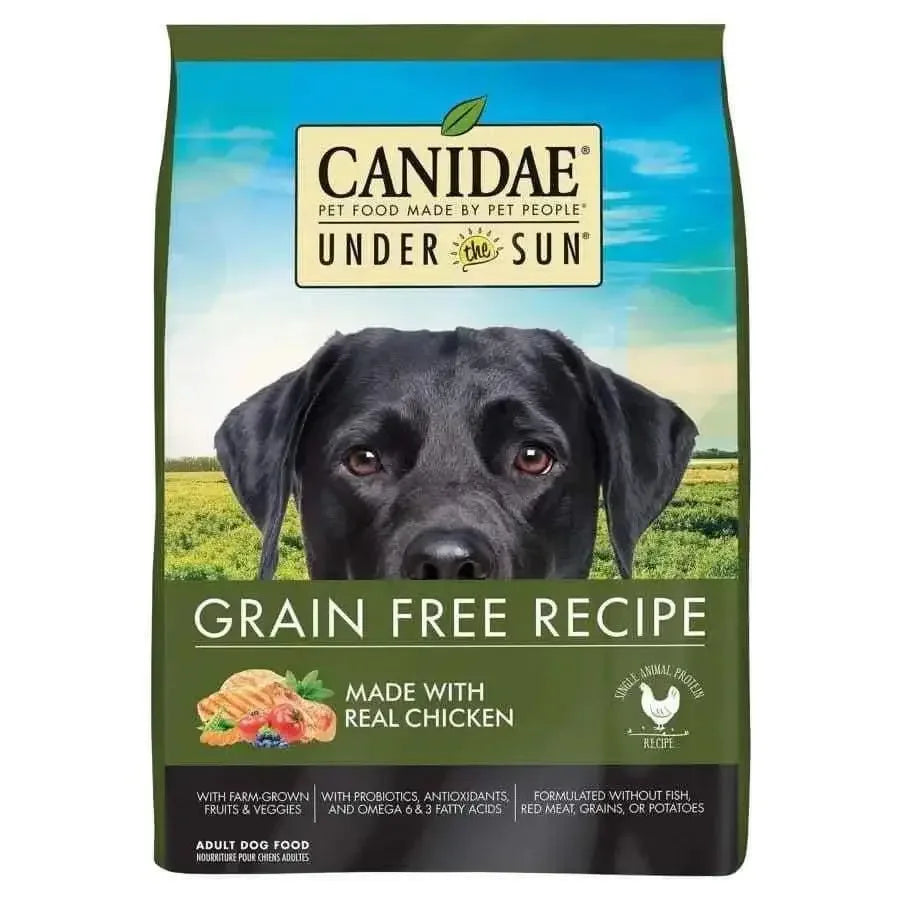 A bag of CANIDAE Under The Sun Grain-Free Chicken Recipe Dry Dog Food with a black dog’s face, green background, and text showcasing real chicken, farm-grown ingredients, fruits, and vegetables.