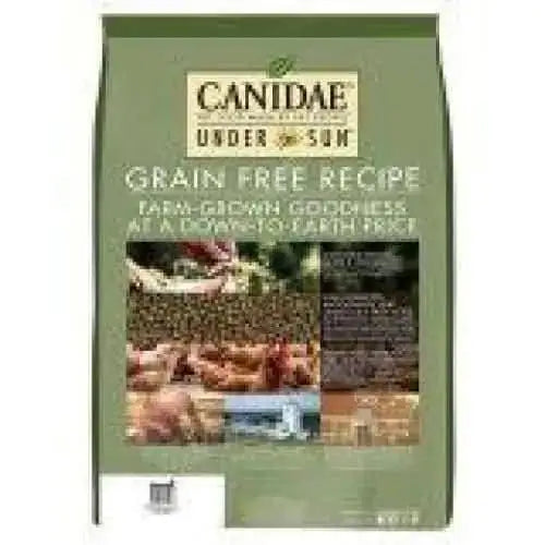 A green bag of CANIDAE Under The Sun Grain-Free Chicken Recipe Dry Dog Food, featuring images of crops and farm-grown ingredients, highlights this grain-free chicken recipe made with quality produce.