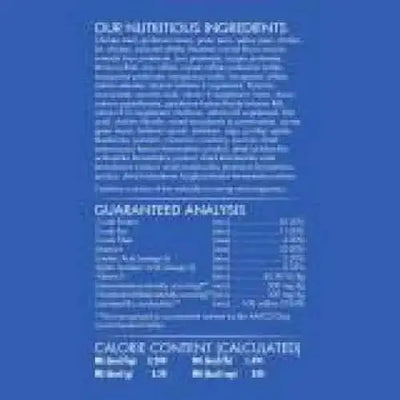 A blue label with white text highlights CANIDAE Under The Sun Grain-Free Large Breed Chicken Recipe Dry Dog Food’s single animal protein ingredients. The label also lists a nutrient table and calorie info, but the text is mostly unreadable.