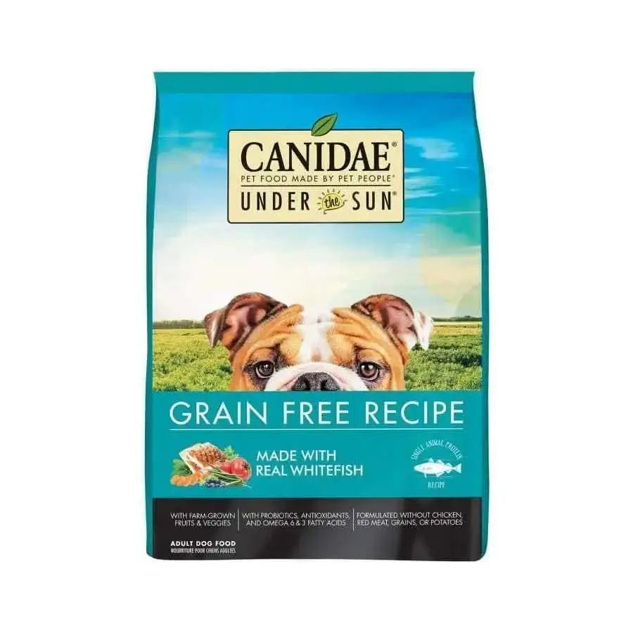 Bag of CANIDAE Under The Sun Grain-Free Whitefish Recipe Dry Dog Food 23.5 lb, featuring a bulldog in a green field, and text highlighting single animal protein from real whitefish, farm-grown fruits and veggies, plus probiotics.