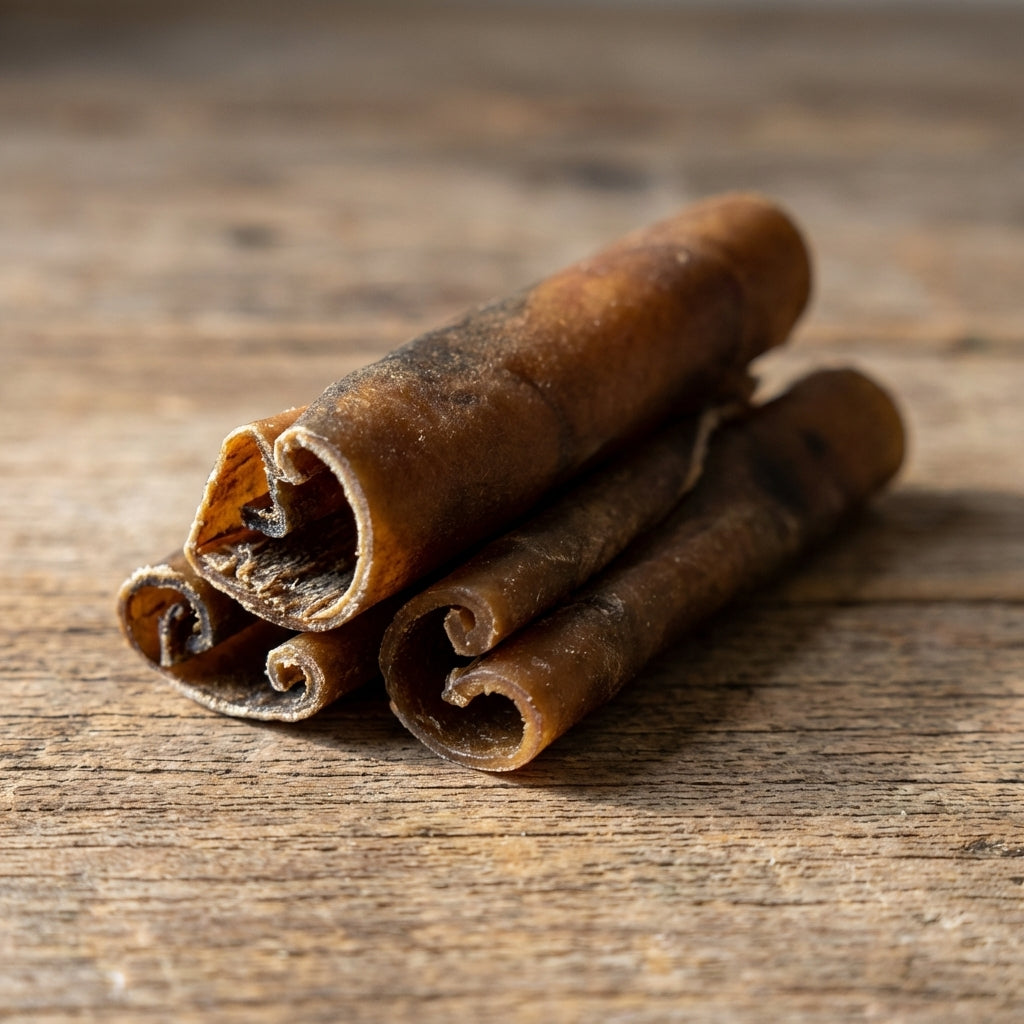 Ultra-realistic close-up of a small camel skin dog chew on textured wood, highlighting rich brown hues and micro-texture.