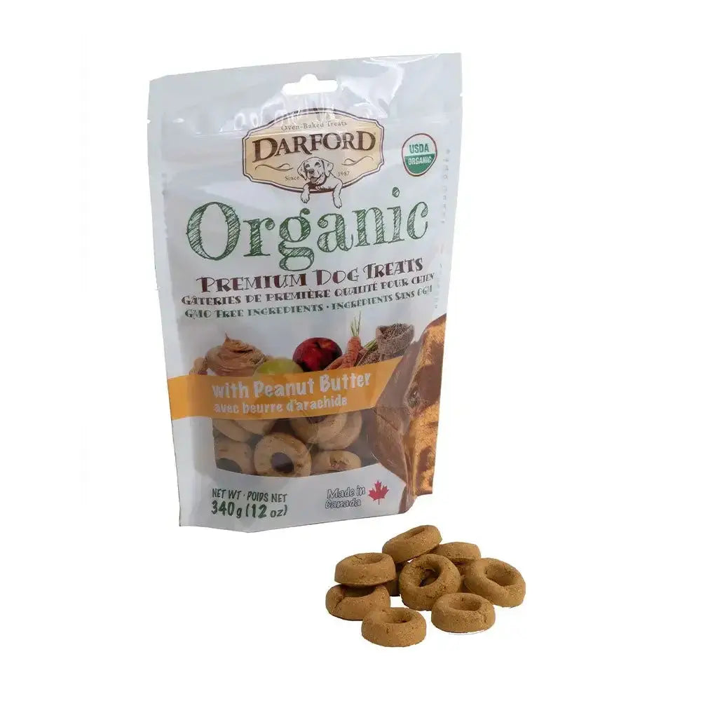 A bag of Darford® Organic Premium Peanut Butter Dog Treat 340 gm/12 Oz stands upright, with several round, brown treats from Darford scattered in front of the package.