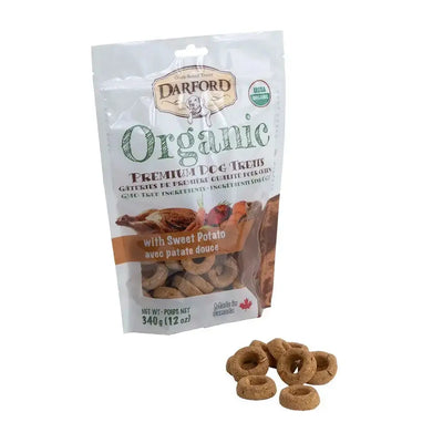 A bag of Darford® Organic Premium Sweet Potato Dog Treat 340 gm/12 Oz stands upright, with several round, brown treats scattered in front, showcasing the healthy snacks from Darford.