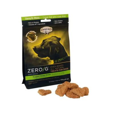 A 6 oz bag of Darford® ZERO/G® Minis Roasted Chicken Dog Treats stands upright with a black dog on the packaging. Several heart-shaped treats are scattered in front of the bag.