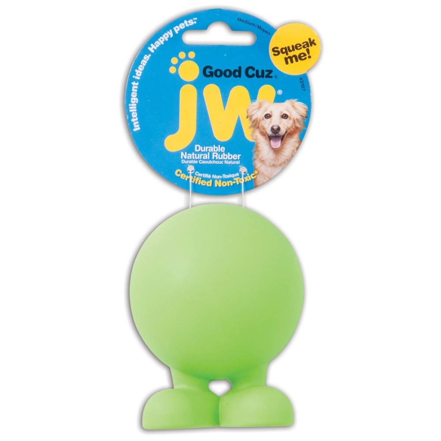 JW Bad Cuz green rubber dog toy with feet and a squeaker, attached to blue and yellow packaging.