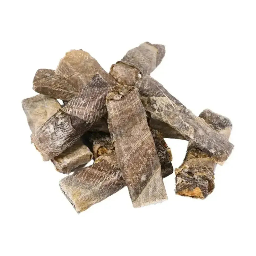 A pile of Momentum Carnivore Nutrition wild-caught cod throw stick dog chews showing natural fish skin texture.