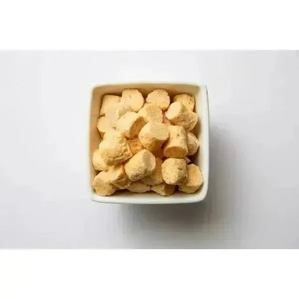 Momentum Carnivore Nutrition 3.5oz single-ingredient freeze dried raw chicken breast dog treats in a white square bowl.