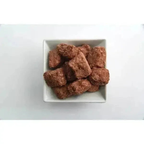 Momentum Carnivore Nutrition freeze-dried raw duck neck dog treats showing crunchy texture in a white square bowl.