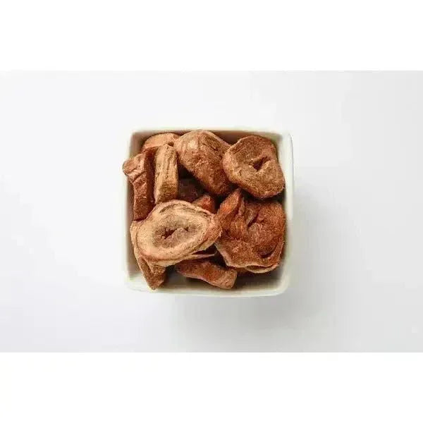 Overhead view of Momentum Carnivore Nutrition freeze-dried raw turkey heart dog treats in a small white square bowl.