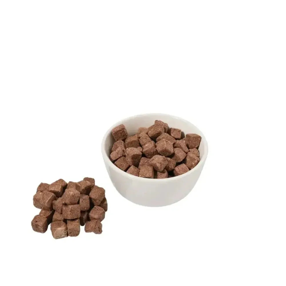 Momentum Carnivore Nutrition grain-free freeze-dried dog training treats in a small white bowl and pile.