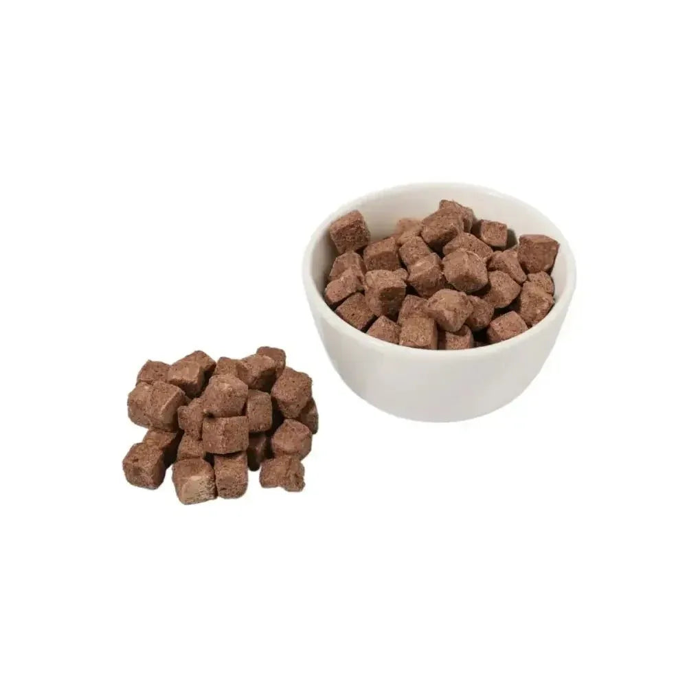 Momentum freeze-dried gut health pet food topper cubes shown in a white bowl and in a pile on a plain background.