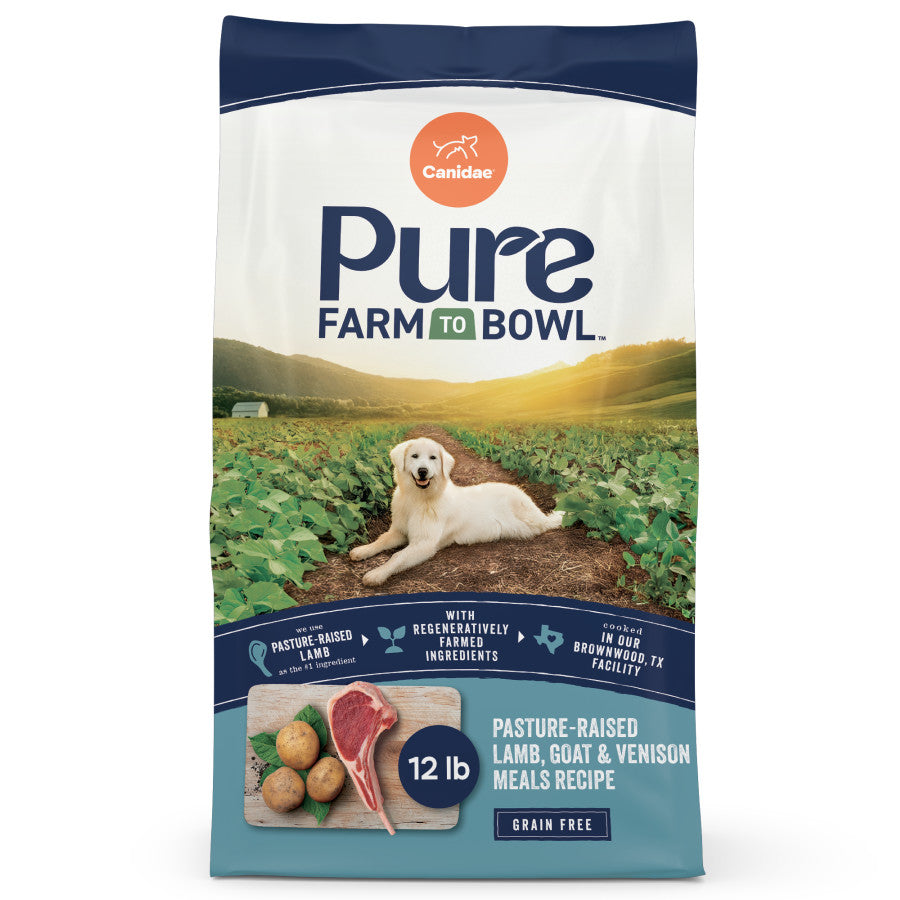 Talis Us CANIDAE PURE Grain-Free Dry Dog Food bag featuring real lamb, goat, and venison with a scenic farm background.