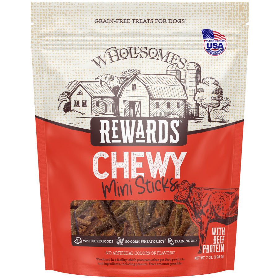 Talis Us Wholesomes Beef Sticks dog treats in a red bag, featuring a farm illustration and labeled as grain-free and chewy.