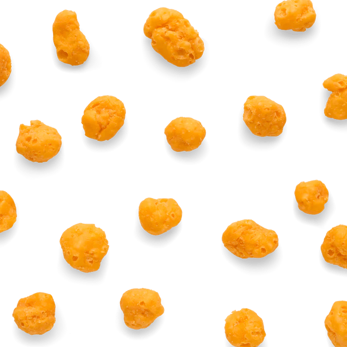 Cheddar cheese dog treats by The Honest Kitchen in fun shapes on a black background