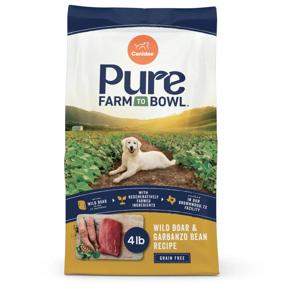Bag of dry dog food, CANIDAE PURE Grain-Free Real Wild Boar & Garbanzo Bean Recipe, featuring a dog in a field.
