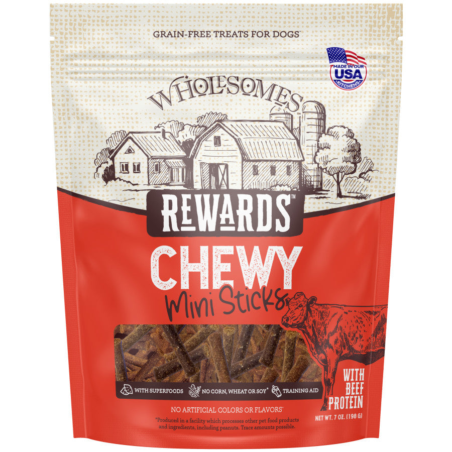 Talis Us Wholesomes Beef Sticks dog treats in a red bag, featuring a farm illustration and labeled as grain-free and chewy.